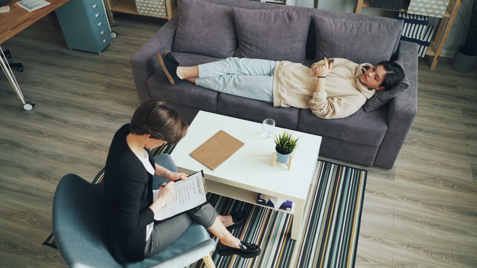 a man and woman sitting on a couch in a living room